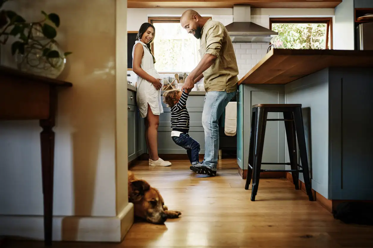 Happy family in kitchen with dog